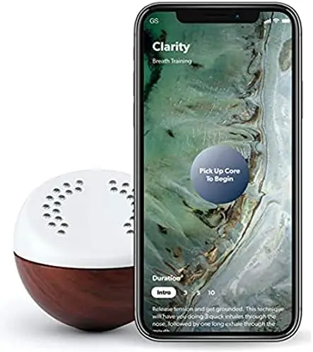 A phone with a wooden ball next to it.