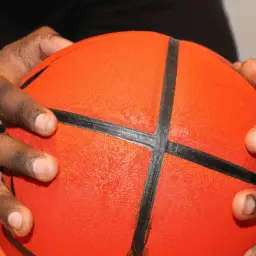 A person holding a basketball in their hands.