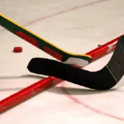 A hockey player's stick is on the ice.